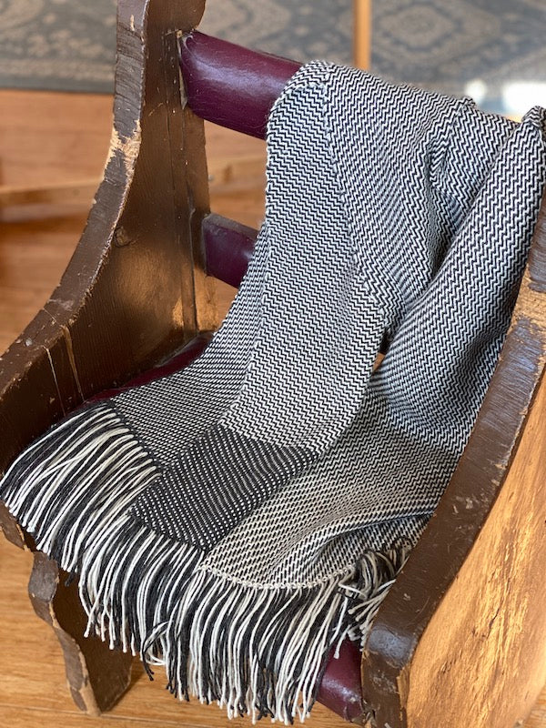 Stole color-and-weave twill in Ode draped on a chair.