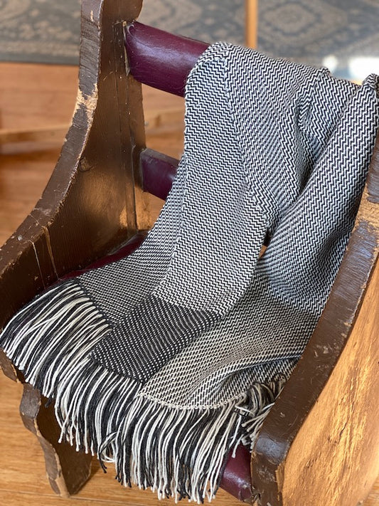 Stole color-and-weave twill in Ode draped on a chair. 