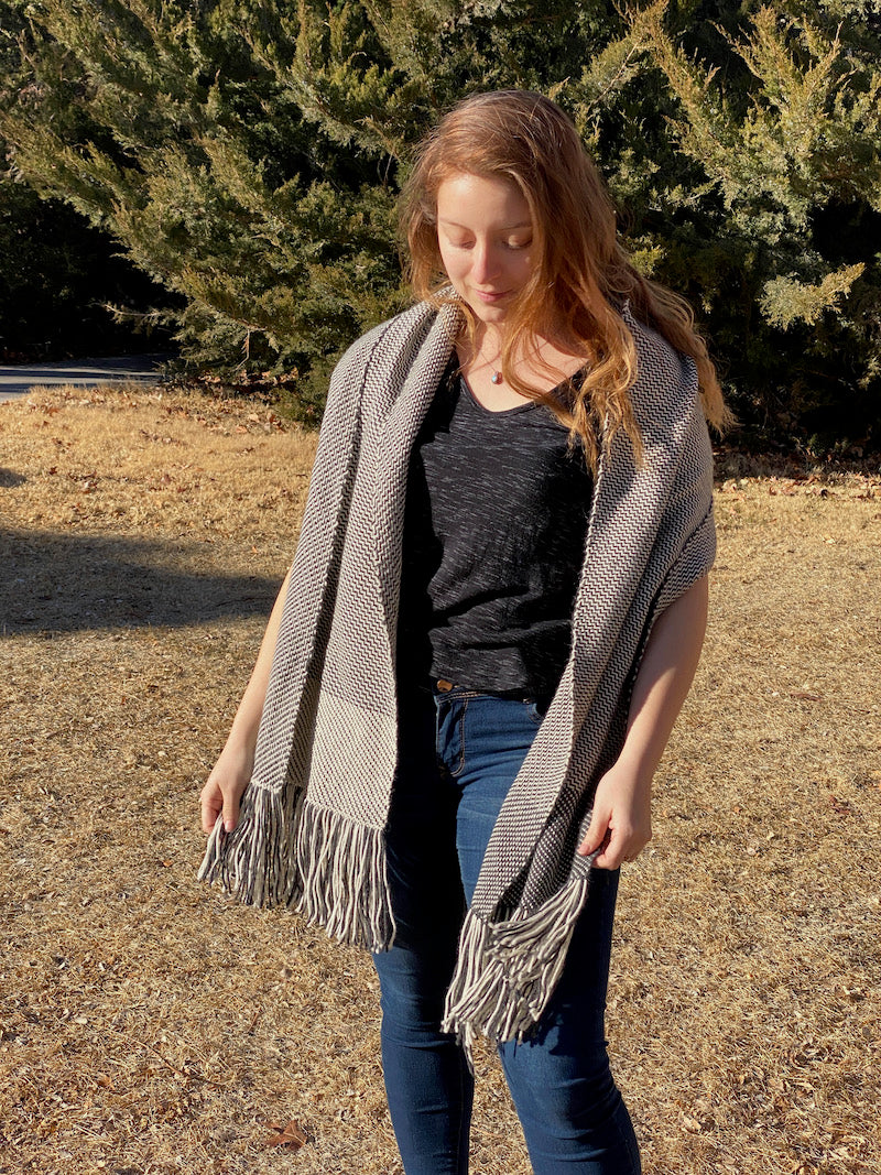 Marrianna wearing black and white color-and-weave stole  outside with a slight breeze. 